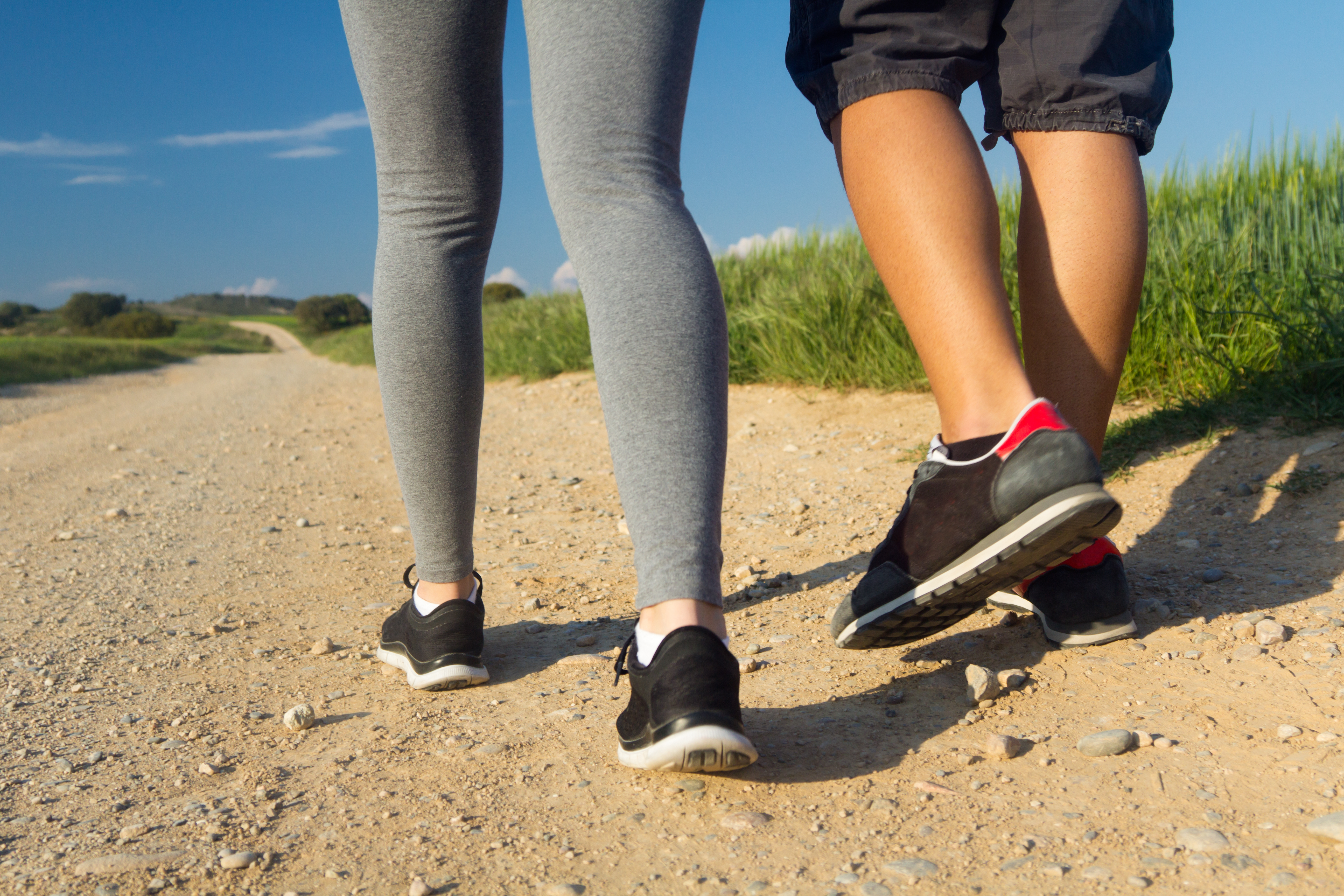 detail of couple legs walking on the field